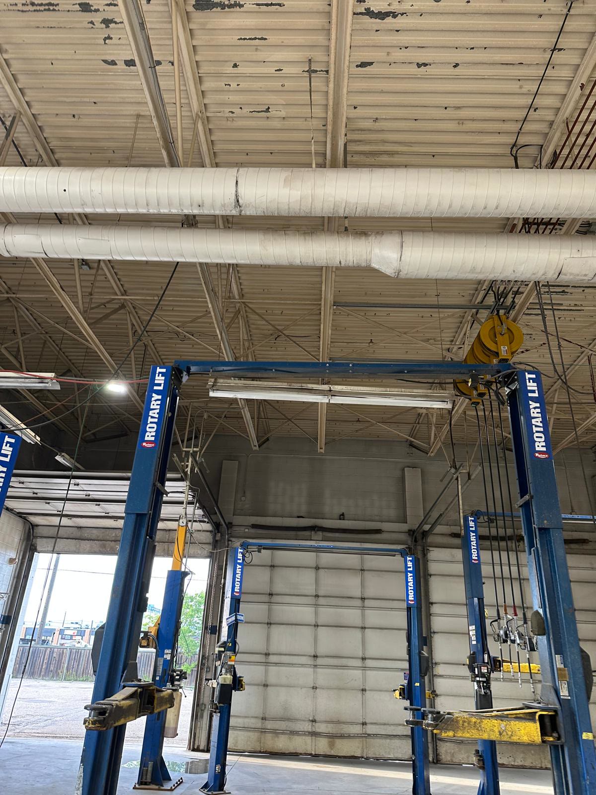 Service bays before painting: discoloured ceiling and trusses above the vehicle lifts