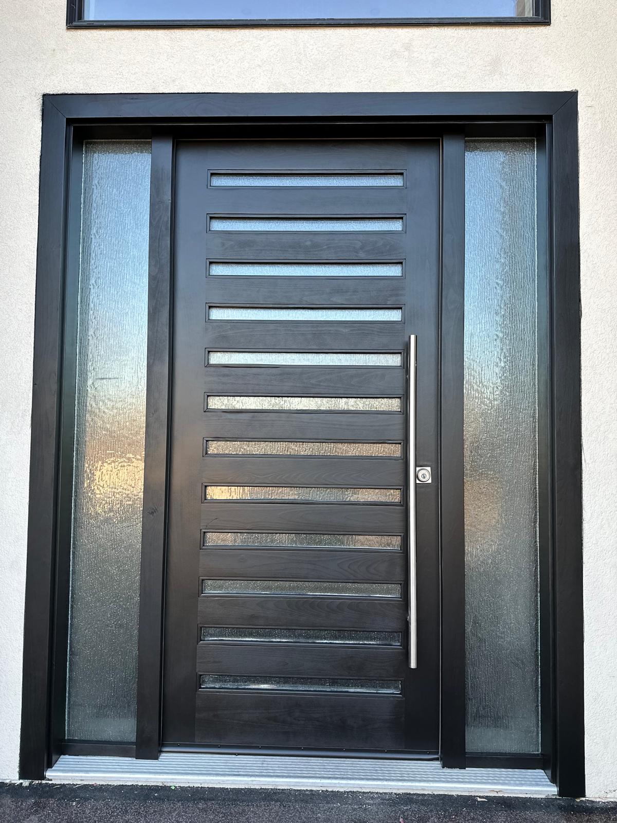 The same front entrance door refinished by Bright Star in a deep satin black with a brushed steel handle